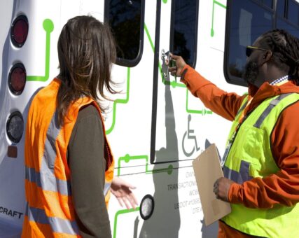 128BC team checking the condition of the shuttle's wheelchair access door