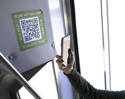 A rider scanning the Tripshot Wallet QR code as they board the shuttle to use mobile ticketing