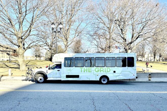 Grid shuttle at Waltham Center pickup stop—our hometown service woven into the town streetscape.