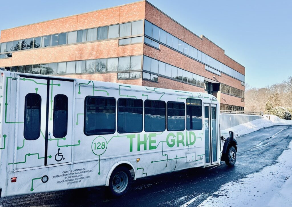 Grid vehicle pulling out of the 80 Hayden Avenue parking lot, with wheelchair access visible.