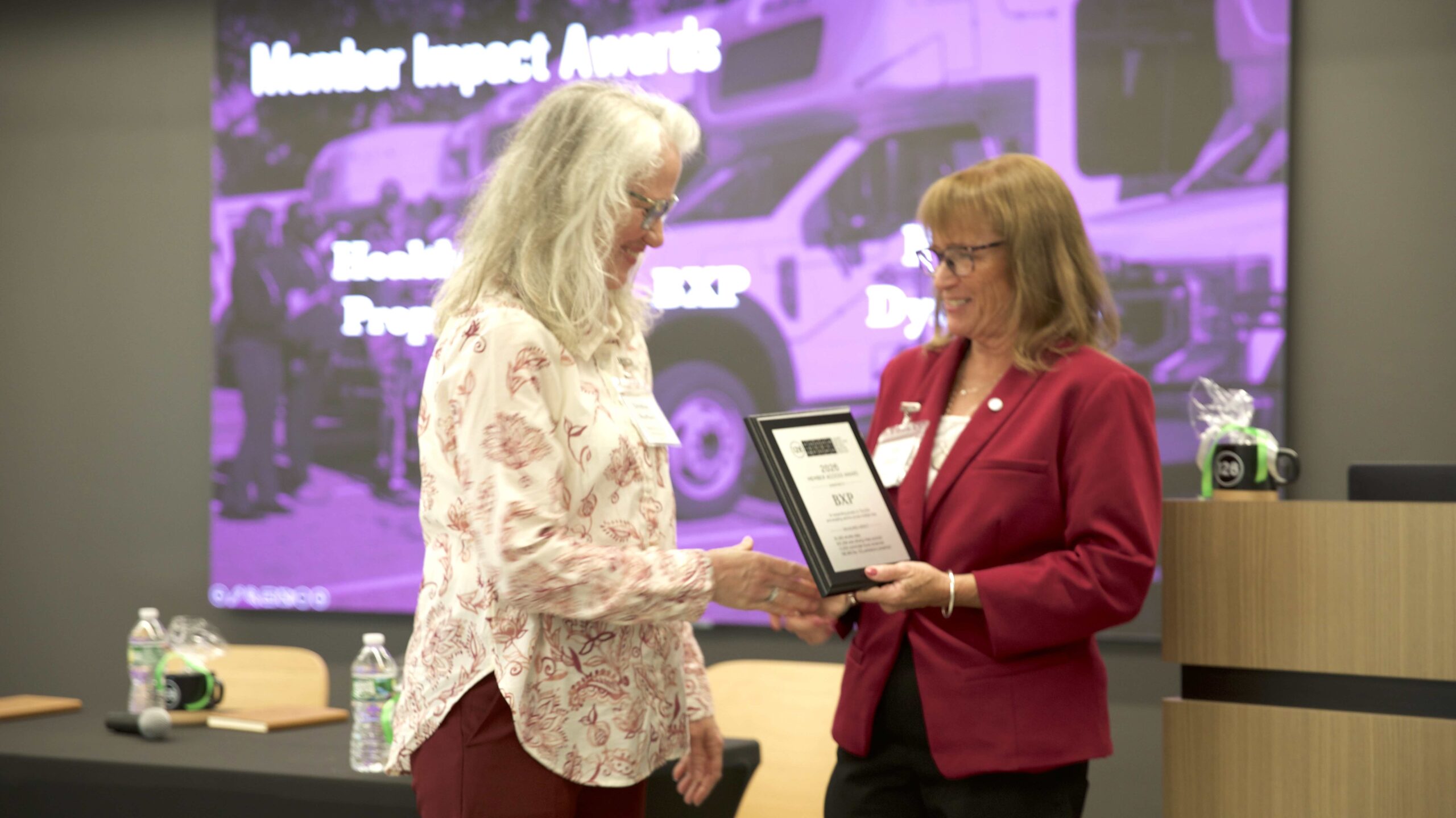 BXP Regional Property Manager Christine Bouffard accepts the Member Access Award from 128BC Executive Director Lisa Stiglich.