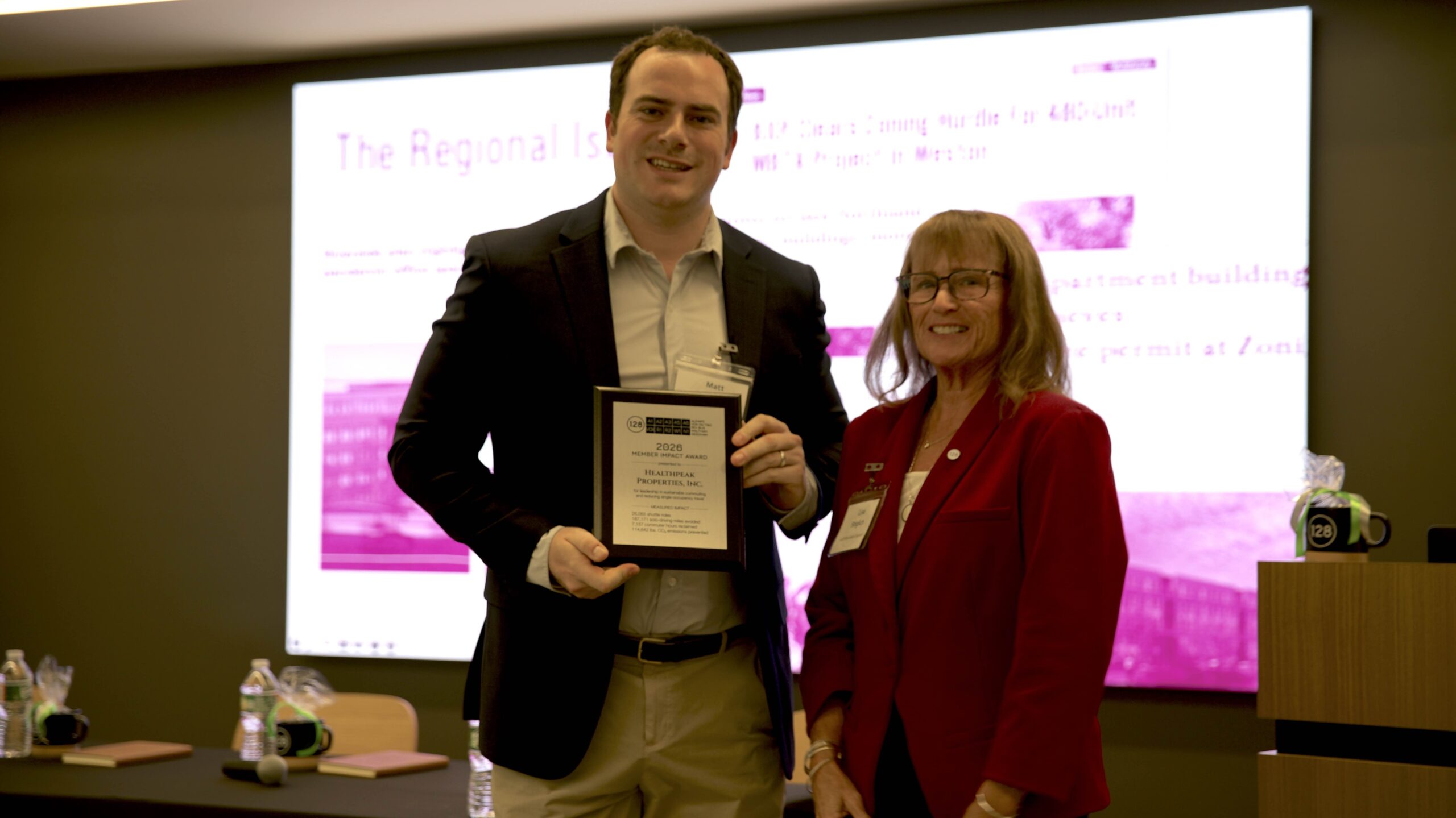 Healthpeak Senior Property Manager Matt Needle accepts the Member Impact Award from 128BC Executive Director Lisa Stiglich.
